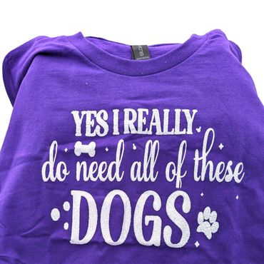 Purple shirt with dog lover quote and paw print design.