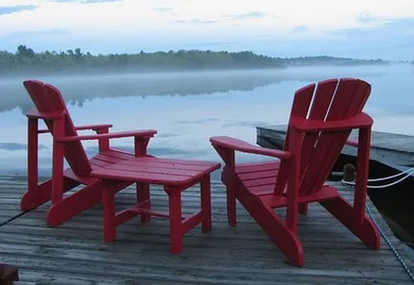 Two chairs overlooking lake