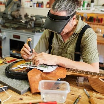picture of a dude repairing a guitar
New Orleans