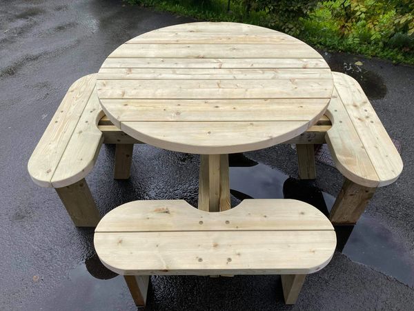 Round wooden 8-seater picnic table with bench seats