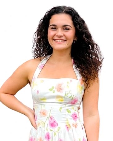 Young woman in floral dress smiling.