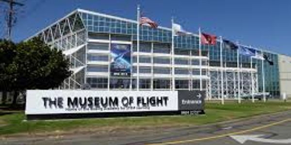 The Museum of Flight building exterior with flags and signage.