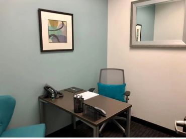 Small office with modern decor and desk setup.