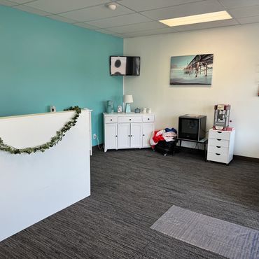 Clean office reception area with blue wall and decorated counter.