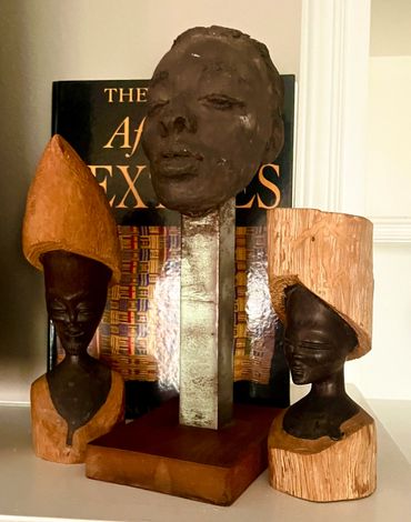 three sculptures on a table 