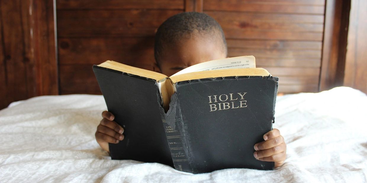 Child reading Bible