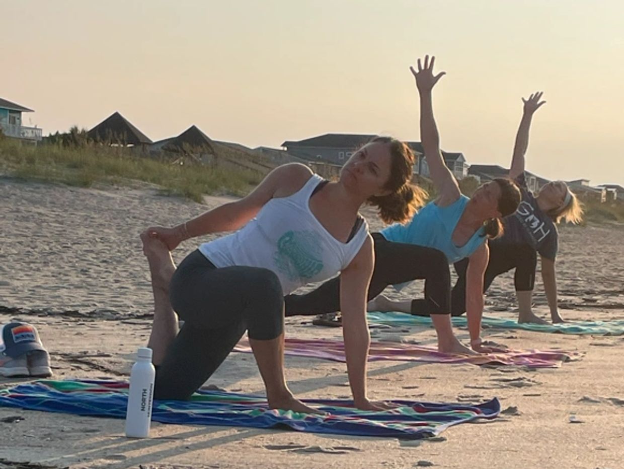 Salute the sun on the beach with Ocean Isle Beach Yoga.  