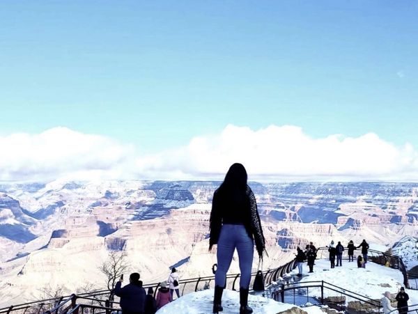 Person overlooking the Grand Canyon on a snowy day.