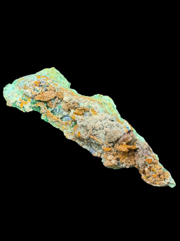 A colorful mineral or rock specimen with rough texture on a black background.
