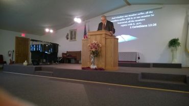 Man delivering a sermon in a church.