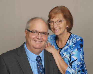 Smiling elderly couple posing together.