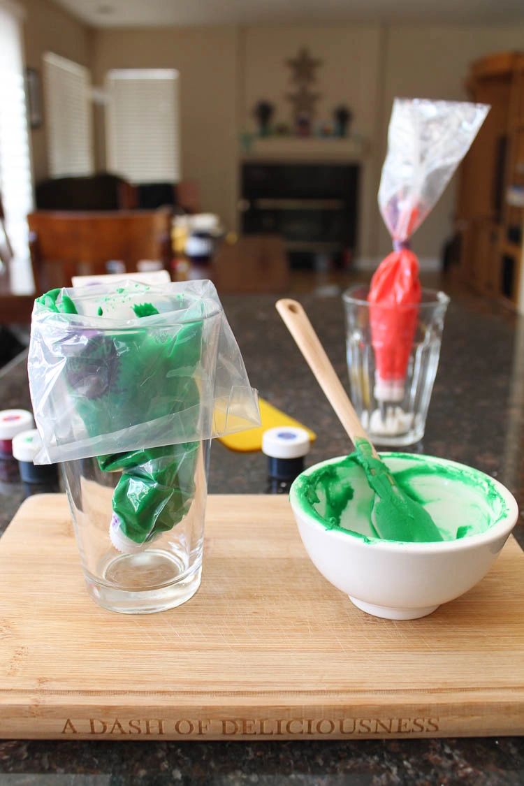 Royal icing in bag held in glass cup.
