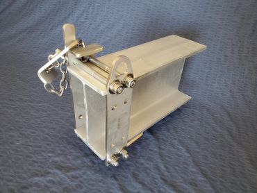 A shiny metal mechanical component on a blue fabric background.