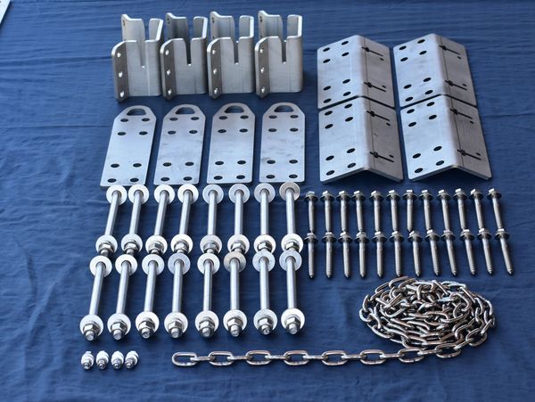 Assorted metal hardware components neatly arranged on a blue cloth.