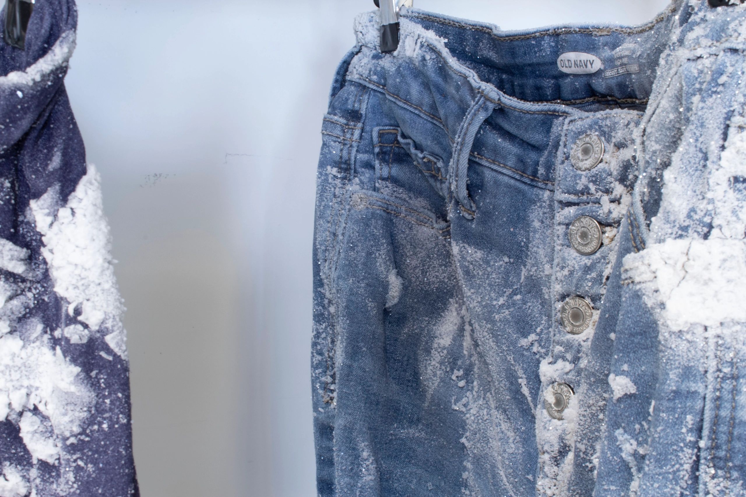 Close up of the top of a pair of jeans covered in salt