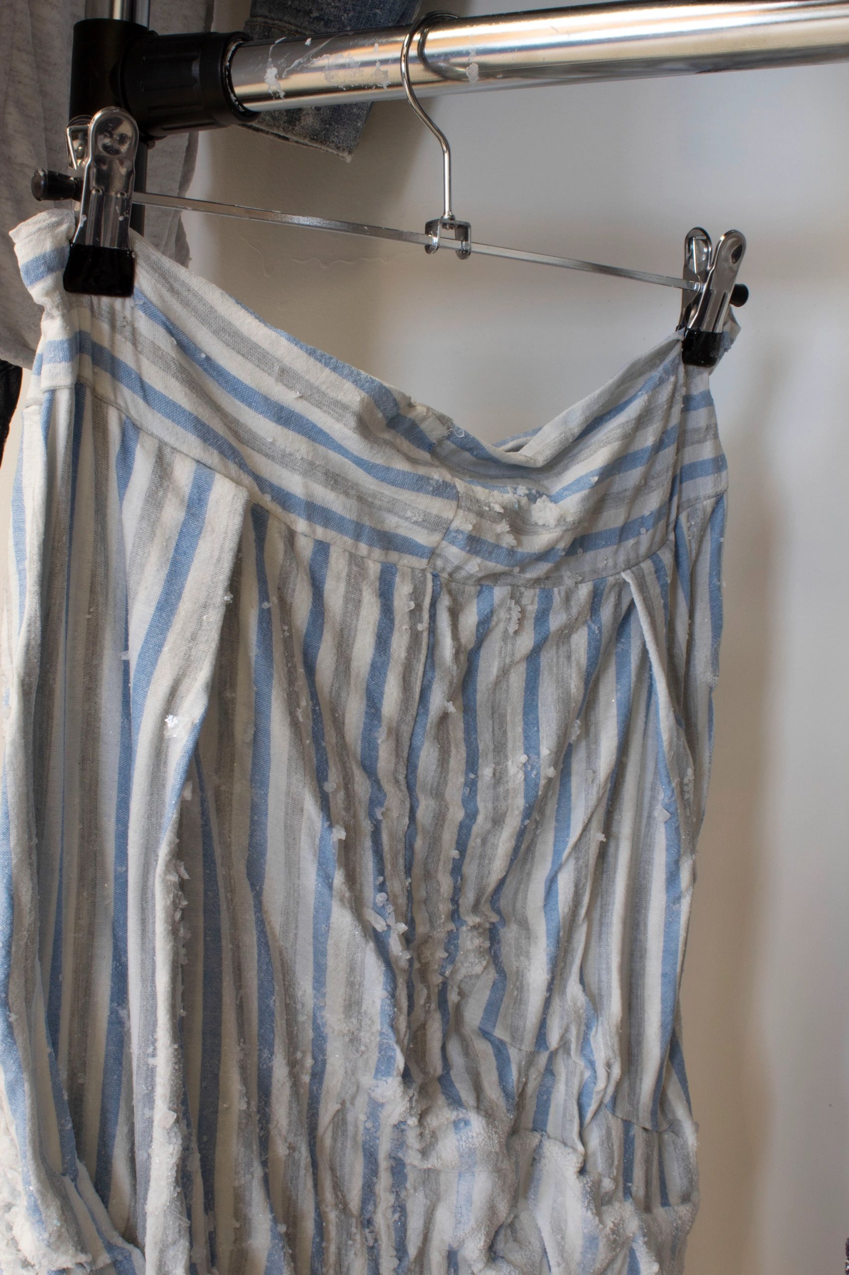 Closeup of a skirt hanging with salt on it.