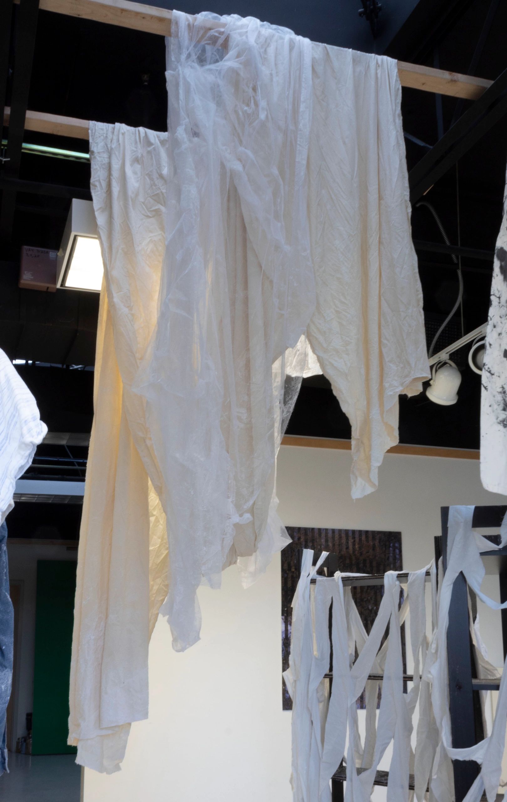 Several feet of off-white fabric are draped from the ceiling