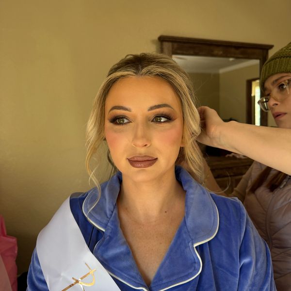 Woman getting her hair styled indoors.
