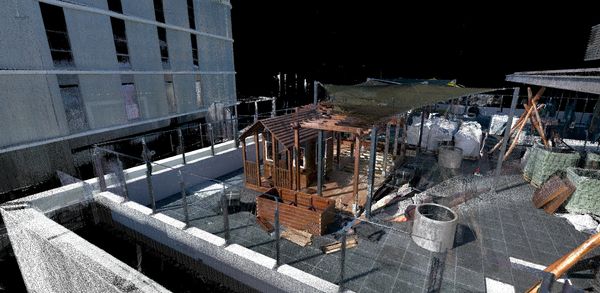3D point cloud of a rooftop with wooden structures and construction materials.