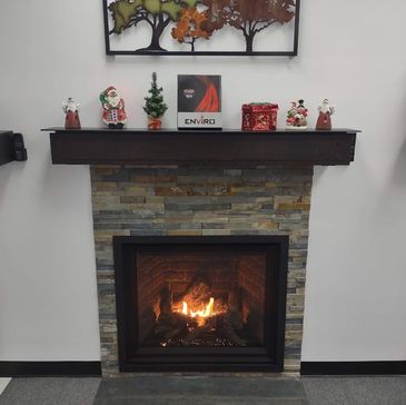 Cozy fireplace with festive Christmas decorations on the mantel.