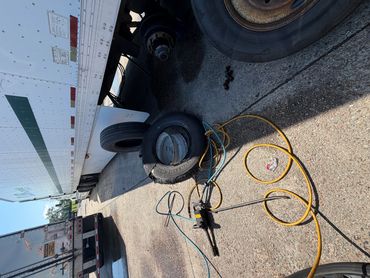 Semi truck steer tire being replaced roadside near a truck stop off Interstate 10.