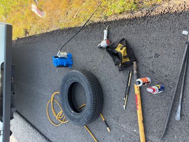 Mobile technician replacing a travel trailer tire at a highway exit in Louisiana Interstate 10.