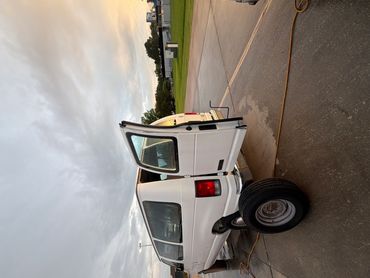 Changing Cargo Van Tire Off Corporate & College Dr Baton Rouge Louisiana off I-10.