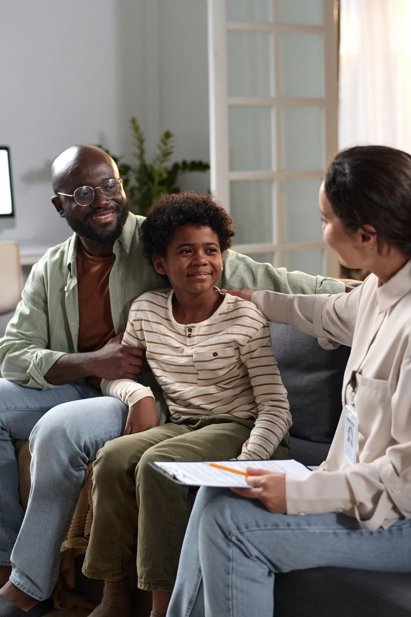 Father and son with a counselor discussing.