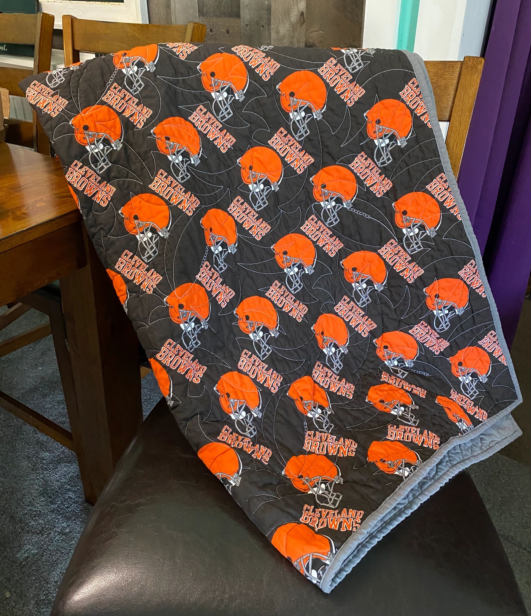 Cleveland Browns quilt draped over a chair.
