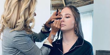 A woman applying makeup to another woman.