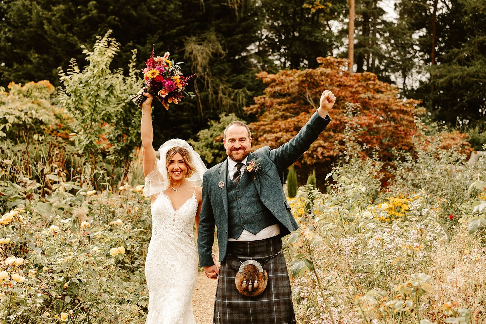 Bride and groom in the gardens at the rufflets country house hotel with autumn wedding g theme