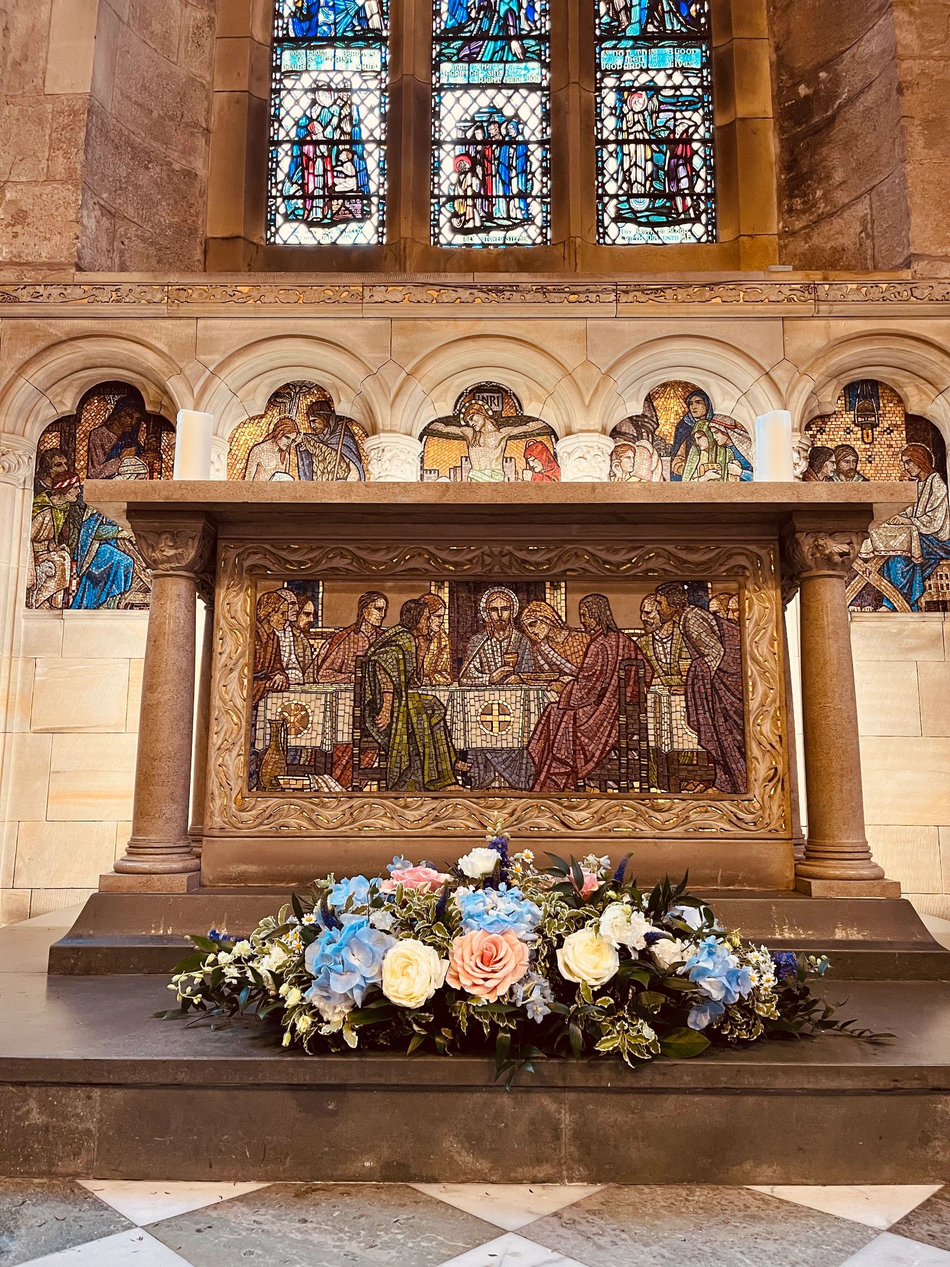 Long and low flowers  in front of alter at St Salvator’s Chapel in St Andrews with pastel flowers