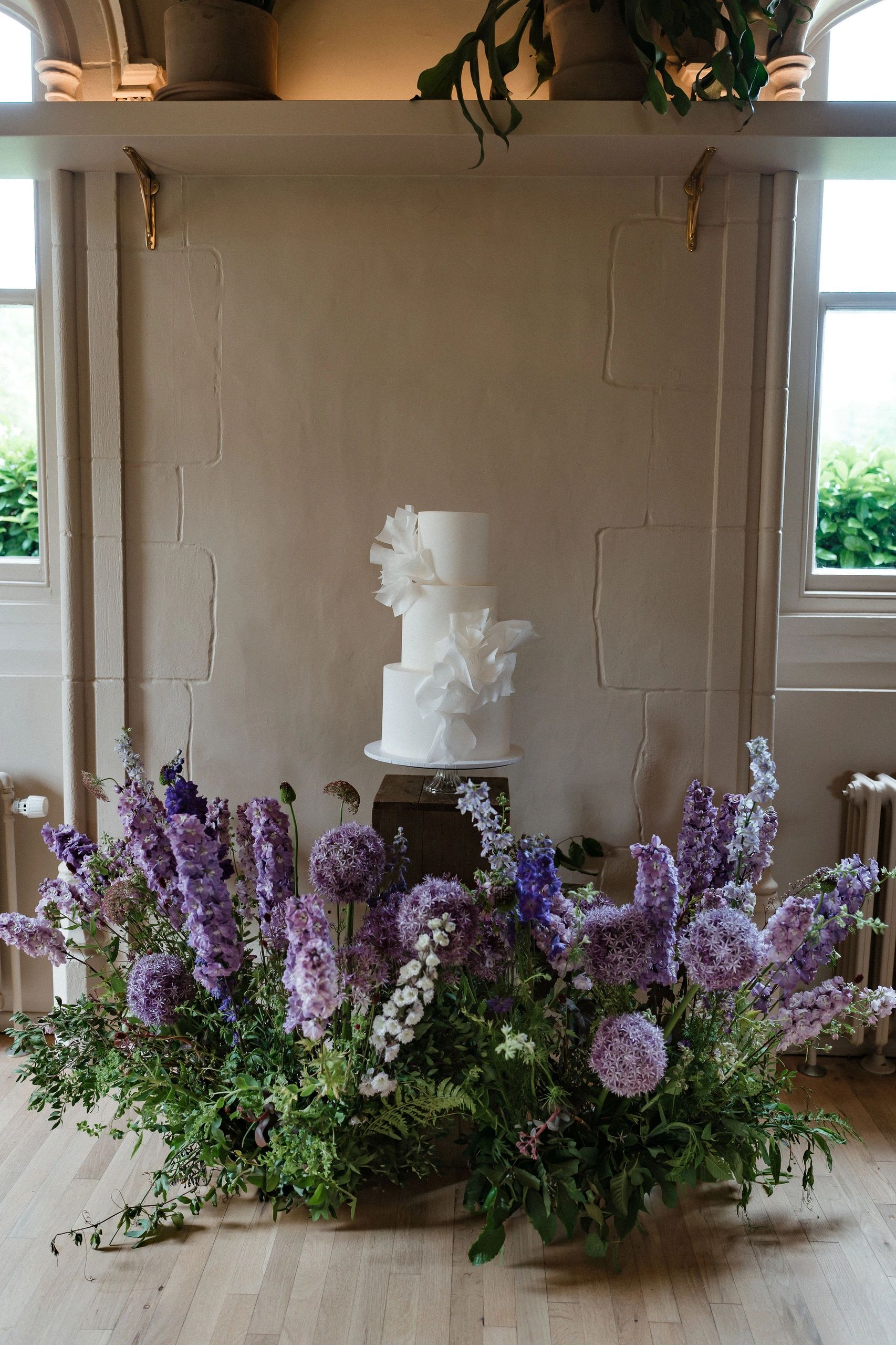 Wedding cake surrounded by fresh flowers