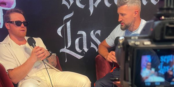 Two men in conversation during a recorded interview.