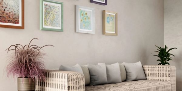 Cozy patterned sofa with cushions under framed artwork.