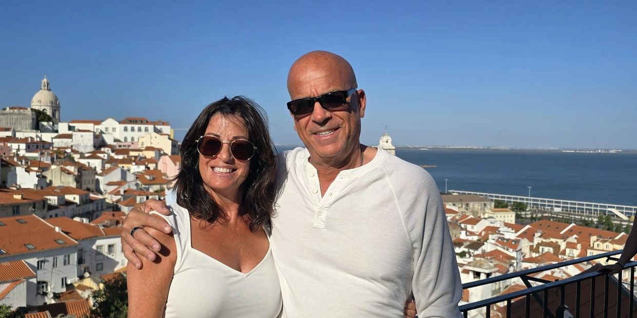 Dennis & Mary of www.dennisandmarytraveldeals.com overlooking Alfama Portugal