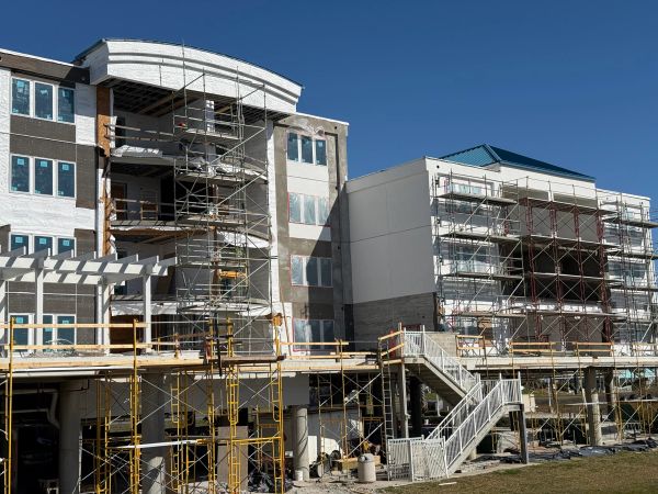 Construction site of a multi-story building with scaffolding.