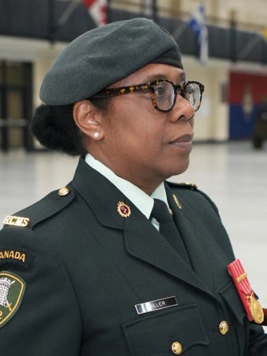 Canadian military officer in uniform with medals and glasses.
