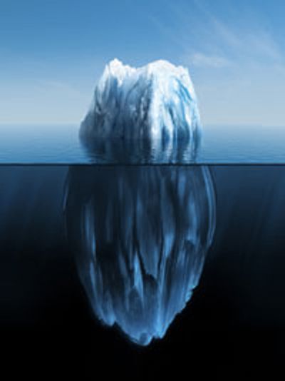Iceberg floating with a small visible tip above water and a large submerged base.