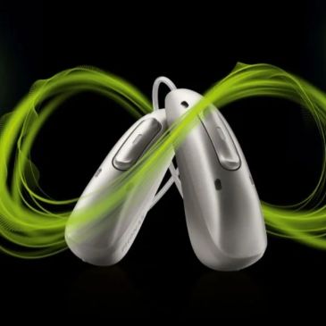 Two modern hearing aids with green sound waves.