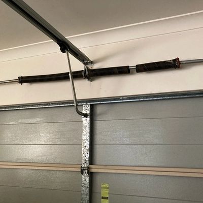 A broken garage door spring on a sectional garage door