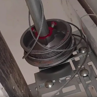 A broken garage door cable