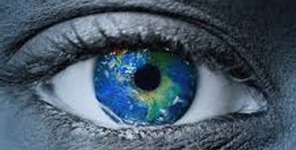Close-up eye with Earth reflected in the iris.
