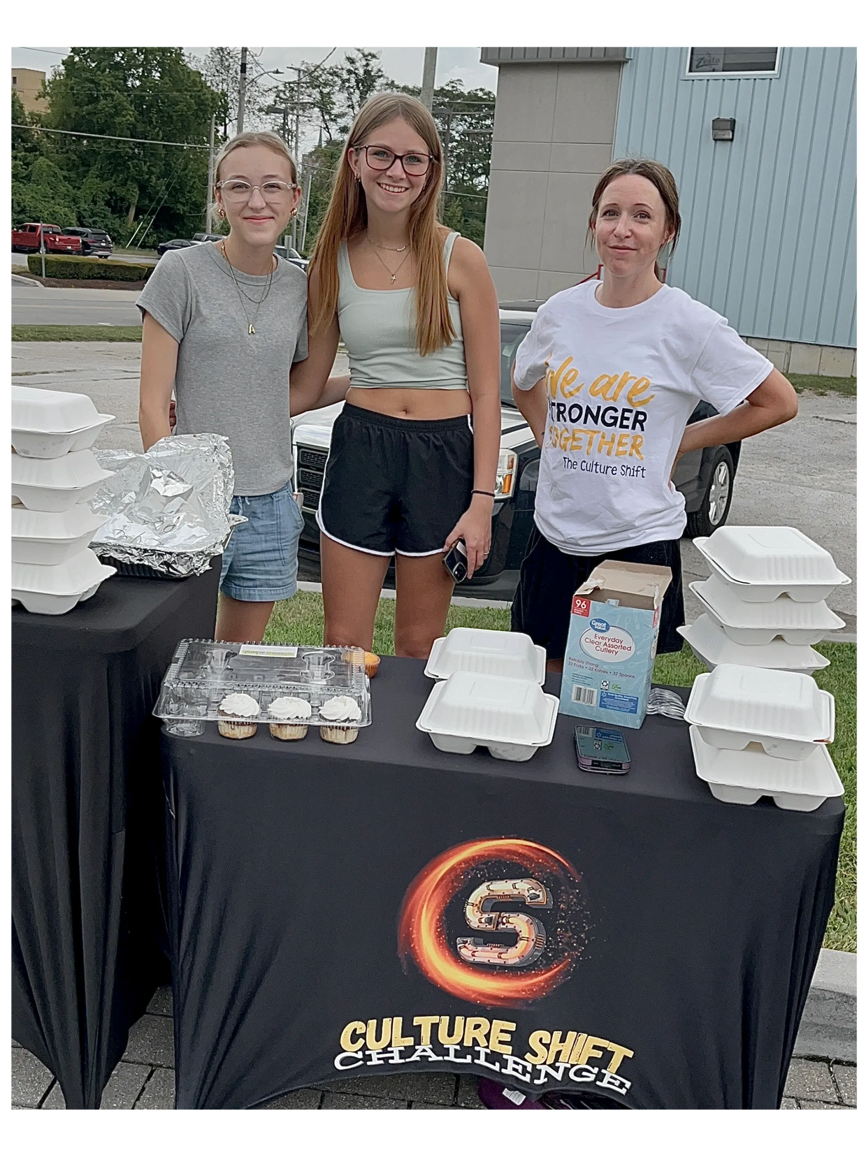 Group of 3 females with meals to be given away to the hungry & unhoused in Downtown Fort Wayne
