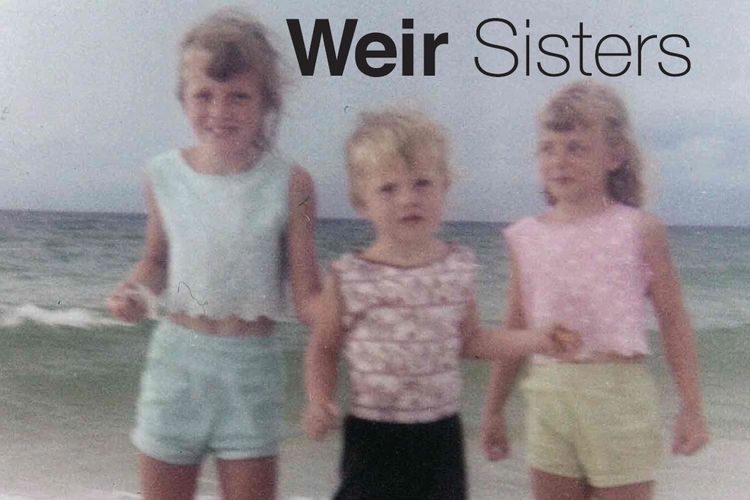 photo of sisters young on the beach.
