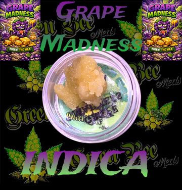 Close-up of Grape Madness Indica THC wax in a container with vibrant branding.
