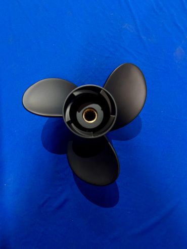 Black three-blade propeller on a blue background.