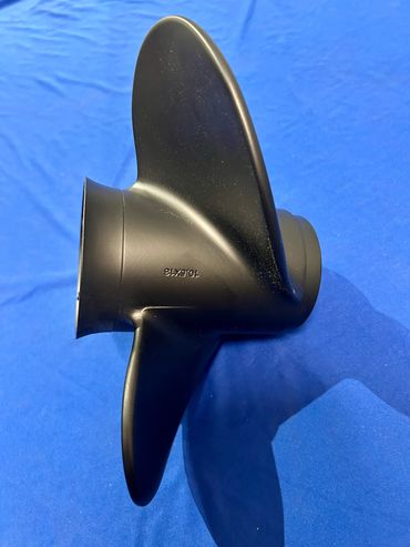 Black propeller on a blue fabric background.