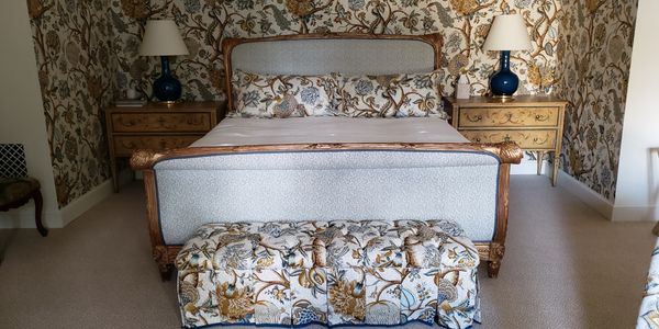 Elegant bedroom with floral motifs and classic furniture.