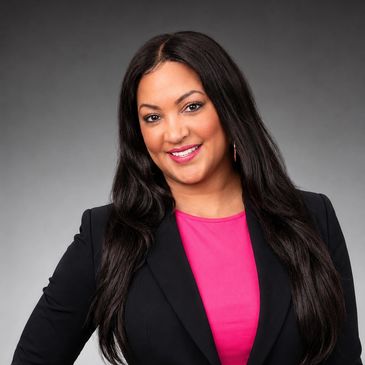 Confident woman smiling in professional attire.